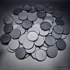 Collection of 50mm round bases lying together on a black background