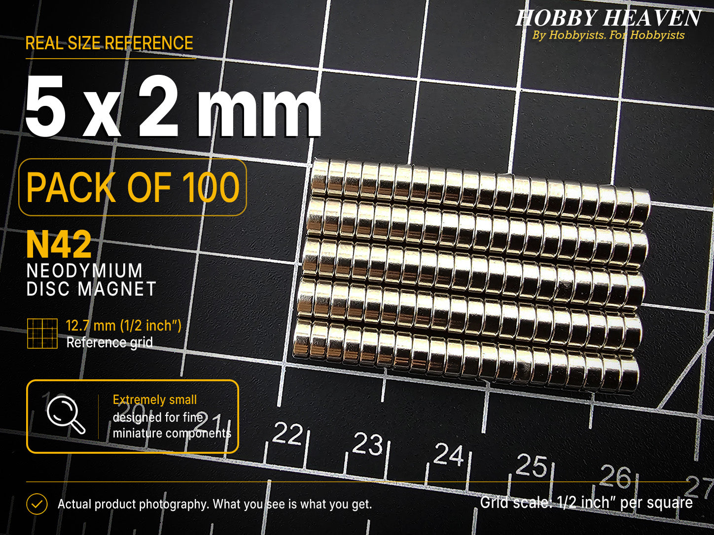 Pack of 100 - one hundred 5 x 2 mm N42 neodymium disc magnets in long stacked rows on a half-inch reference grid