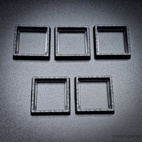 Five 20-25mm square base converters arranged showing size and texture detail

