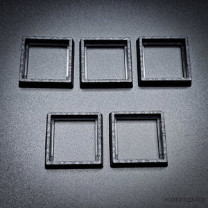 Five 20-25mm square base converters arranged showing size and texture detail
