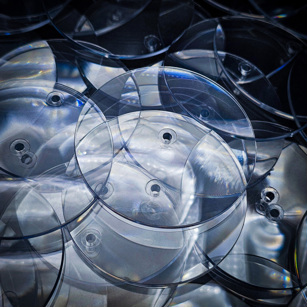 Close-up of 60mm clear round base with centre hole for flying stem, Open Basing System by Hobby Heaven