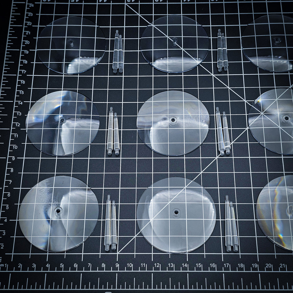 60mm clear round base with polycarbonate flying stems on cutting mat, tabletop miniature basing set