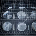 60mm clear round base with polycarbonate flying stems on cutting mat, tabletop miniature basing set
