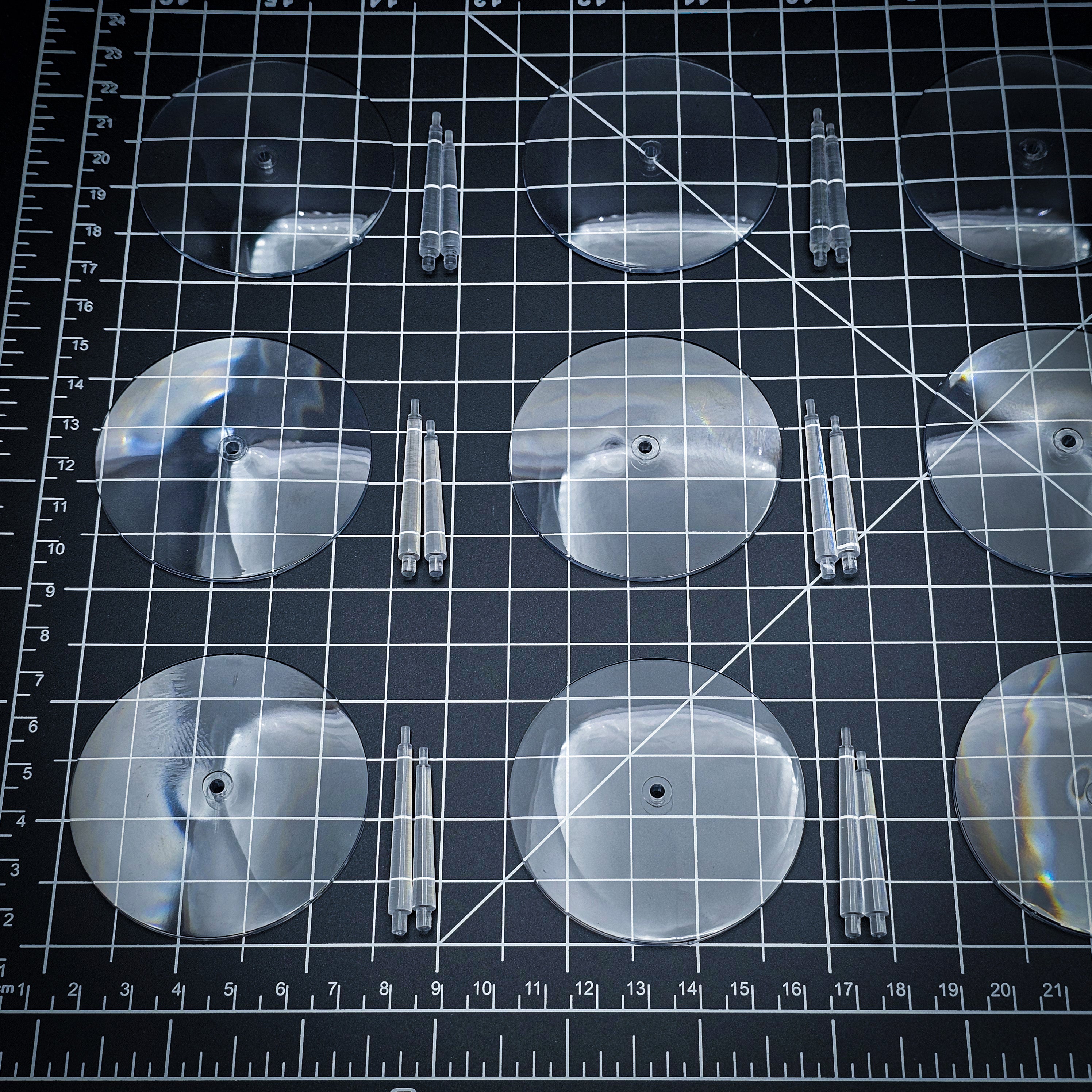 60mm clear round base with polycarbonate flying stems on cutting mat, tabletop miniature basing set