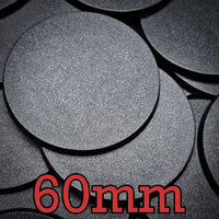 Detailed close-up of several 60mm round bases on a black backdrop, showcasing their finish
