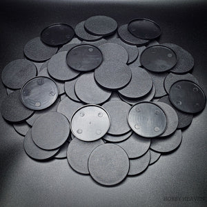 Detailed view of 60mm round bases on black background, emphasizing texture and design