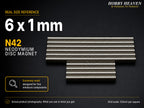 Stacked rows of 6 x 1 mm N42 neodymium disc magnets shown at real size on a half-inch reference grid
