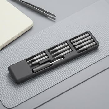 DSPIAE SD-S01 bit case open on a grey desk mat, bits in three rows with the bit holder below