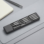 DSPIAE SD-S01 bit case open on a grey desk mat, bits in three rows with the bit holder below