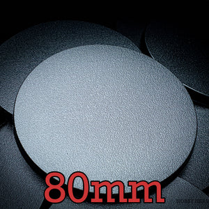 Top view of 80mm round bases against a dark backdrop