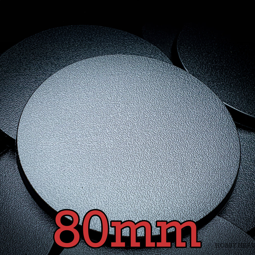 Top view of 80mm round bases against a dark backdrop