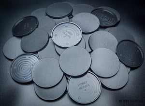 Top view of 80mm round bases against a dark backdrop