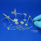 Built, unpainted example of the kit on a blue background: both weapons, tripods, post mount, boxes and projectiles