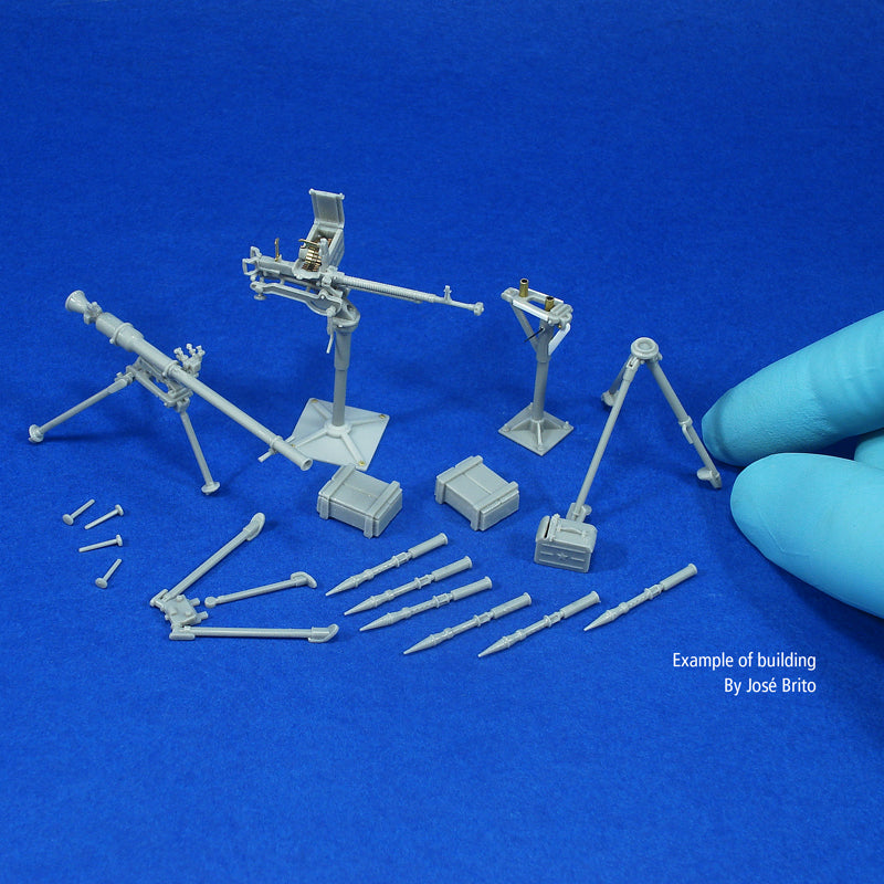 Built, unpainted example of the kit on a blue background: both weapons, tripods, post mount, boxes and projectiles