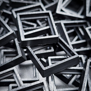 Close-up of injection moulded base converters 20mm to 25mm square size