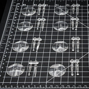 clear acrylic 32mm flying bases on a dark surface.