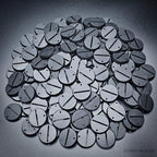 Detailed close-up of 32mm round slotted bases on a pile of various bases.