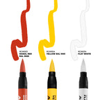 Close-up of three AK Tactical Markings acrylic markers in Signal Red, Yellow and Flat White