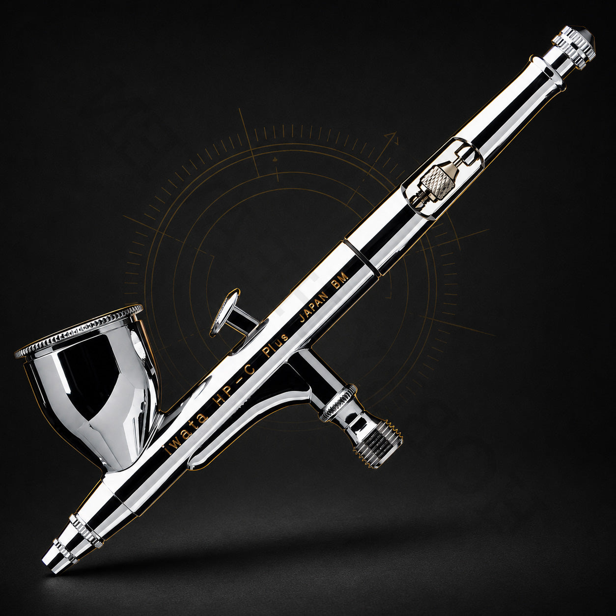 Iwata HP-C Plus at an angle against black, showing the trigger, needle-chucking nut and cutaway handle