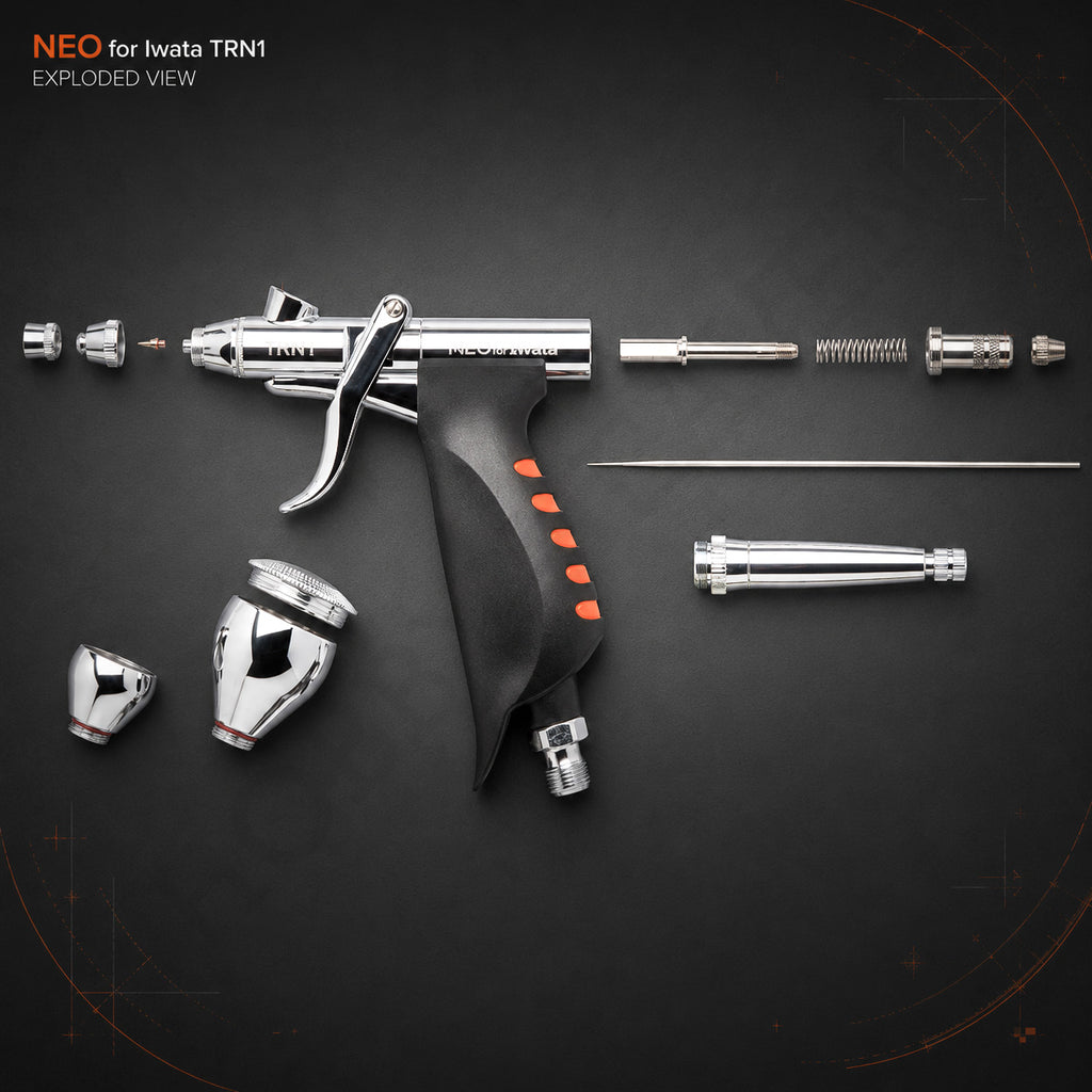 Exploded view of the Neo TRN1: nozzle cap, nozzle, needle, spring, both fluid cups, grip and pre-set handle