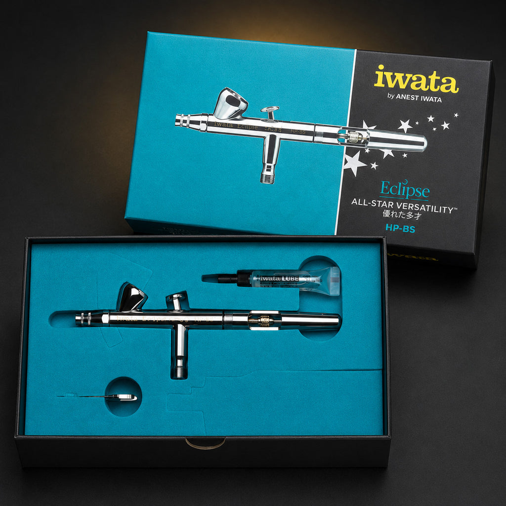 Iwata Eclipse HP-BS in its open teal presentation box with a tube of Iwata Lube in the upper recess