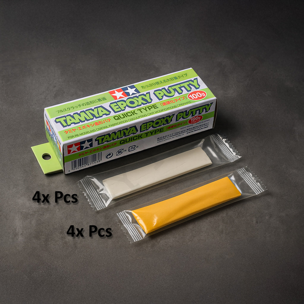 Tamiya Epoxy Putty Quick Type 100g box on a dark surface with a white putty and a beige hardener strip