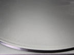 Close-up of the edge of the 300mm round smooth PLA base showing FDM layer lines in detail along the bevelled rim.
