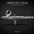 Iwata HP-C Plus airbrush side-on against black, 7 ml gravity cup uppermost, engraved iwata HP-C Plus JAPAN