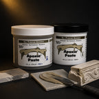 Aves Apoxie Paste Part A and Part B jars with khaki paste spread by a palette knife beside stone samples