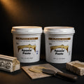 Aves Apoxie Paste Part A and Part B tubs with khaki paste on a knife, a moulded stone corner and a stone block