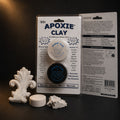 Aves Apoxie Clay quarter-pound White blister card with both jars, a cured white ornament, disc and torn lump