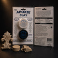 Aves Apoxie Clay quarter-pound Native blister card with both jars, a cured tan ornament, disc and torn lump