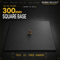 300mm square base hero shot — a single 28mm painted miniature stands on the enormous black square base, demonstrating the absurd scale. Header reads THE 300 INCIDENT FILE 300-SQ.