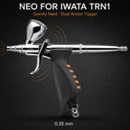 Neo for Iwata TRN1 trigger airbrush against black, 7 ml gravity cup above an orange-ribbed pistol grip