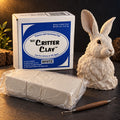 Aves Critter Clay 5 lb White box with white clay blocks in film wrap, a sculpting tool and a sculpted hare