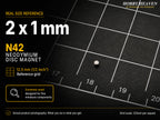Single 2 x 1 mm N42 neodymium disc magnet shown at real size on a half-inch reference grid