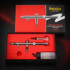 Revolution SAR in its open red-lined box with a tube of Iwata Lube, the 30 ml bottle and a slim metal part