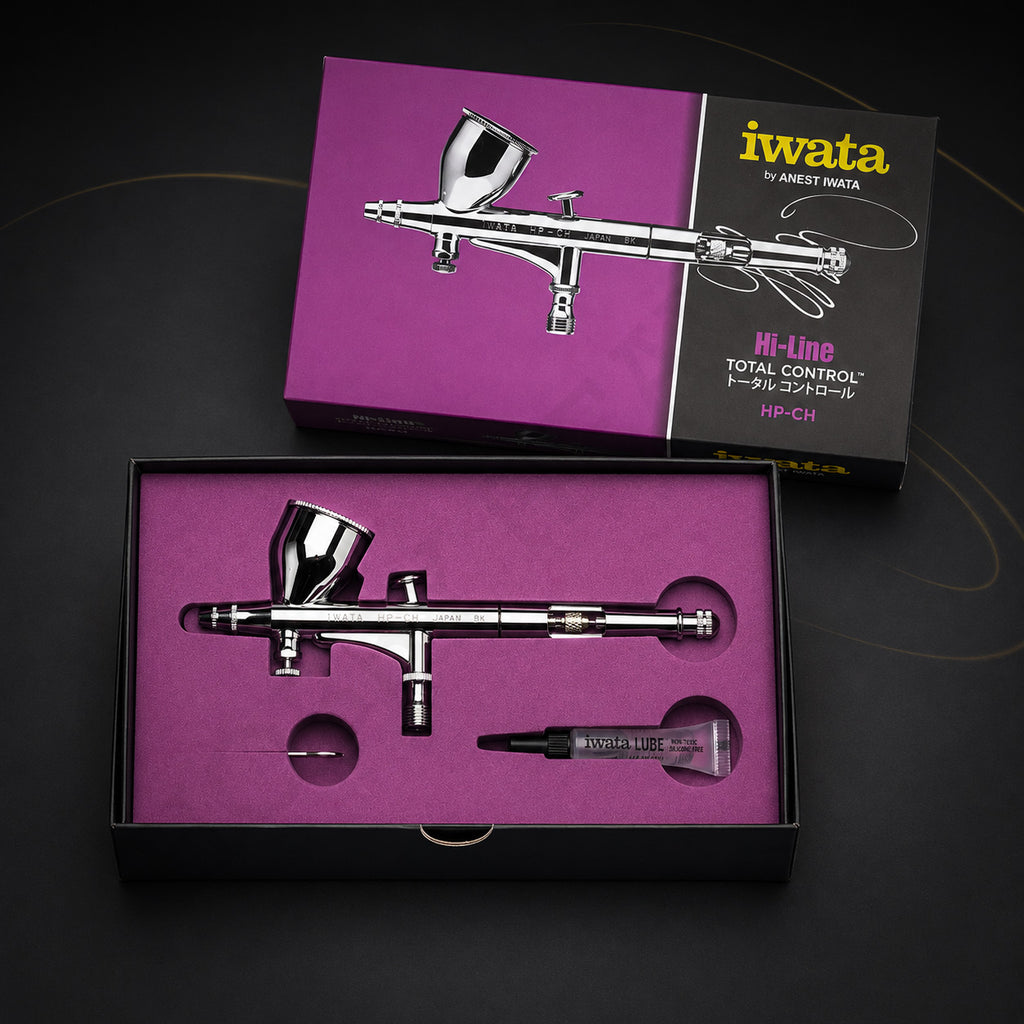 Iwata Hi-Line HP-CH in its open magenta presentation box with a tube of Iwata Lube and a slim metal part