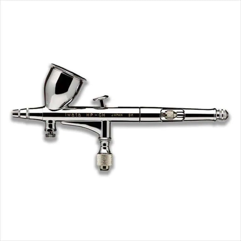 Iwata Hi-Line HP-CH airbrush on a plain white background, full side view with the cup lid in place