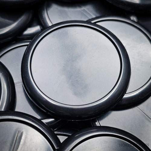 Black 40mm round wide-lip wargaming bases with a raised rim and flat slot-free recessed top, injection-moulded ABS.