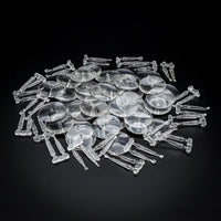 Piled clear acrylic flying bases, 32mm round, on a dark background
