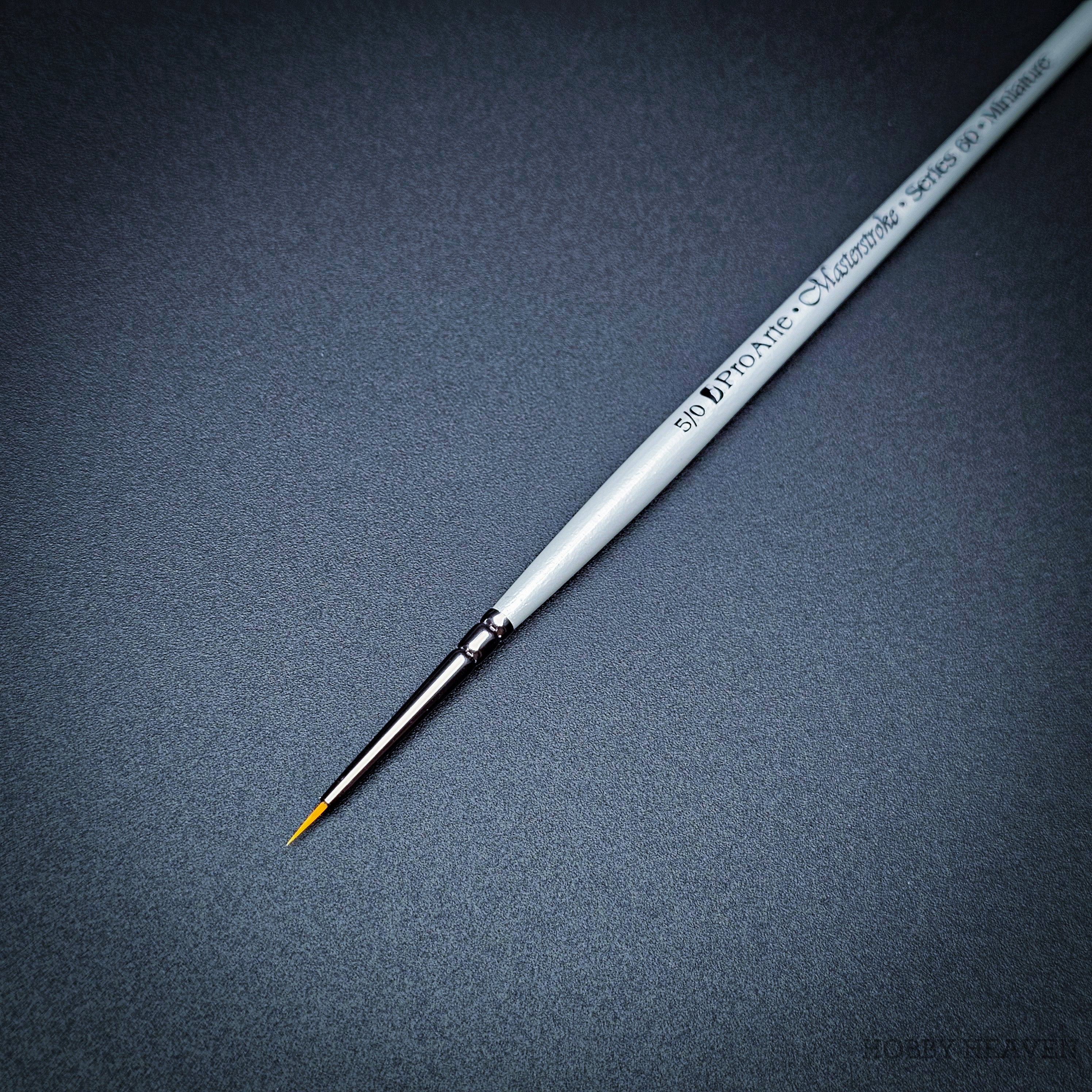 Pro Arte Masterstroke Series 60 – Close-up of size 5/0 Prolon Round Brush on black background.