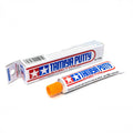Tamiya Putty Basic Type 32g tube with orange cap and matching carton behind it