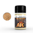 AK147 Middle East Soil: 35 ml AK PIGMENTS jar with a black screw cap, beside a swatch of sandy brown powder