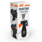 AK Interactive AK9563 Painting Handle retail box showing product with miniature warrior figure mounted, plus two detail images demonstrating 32mm round and 20x20mm square base compatibility