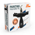 AK Interactive AK9564 Painting Handle XL retail box showing the handle with wide black platform, mounted warrior figure, 40mm and larger badge, and side profile view of the grip mechanism