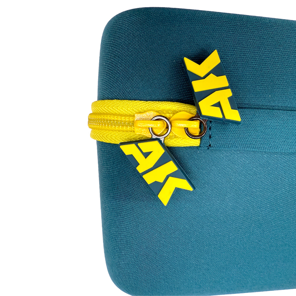 Close-up of AK Interactive Mini Tool Box corner showing two branded rubber AK logo zip pulls in yellow and navy on the yellow zip against teal EVA shell exterior