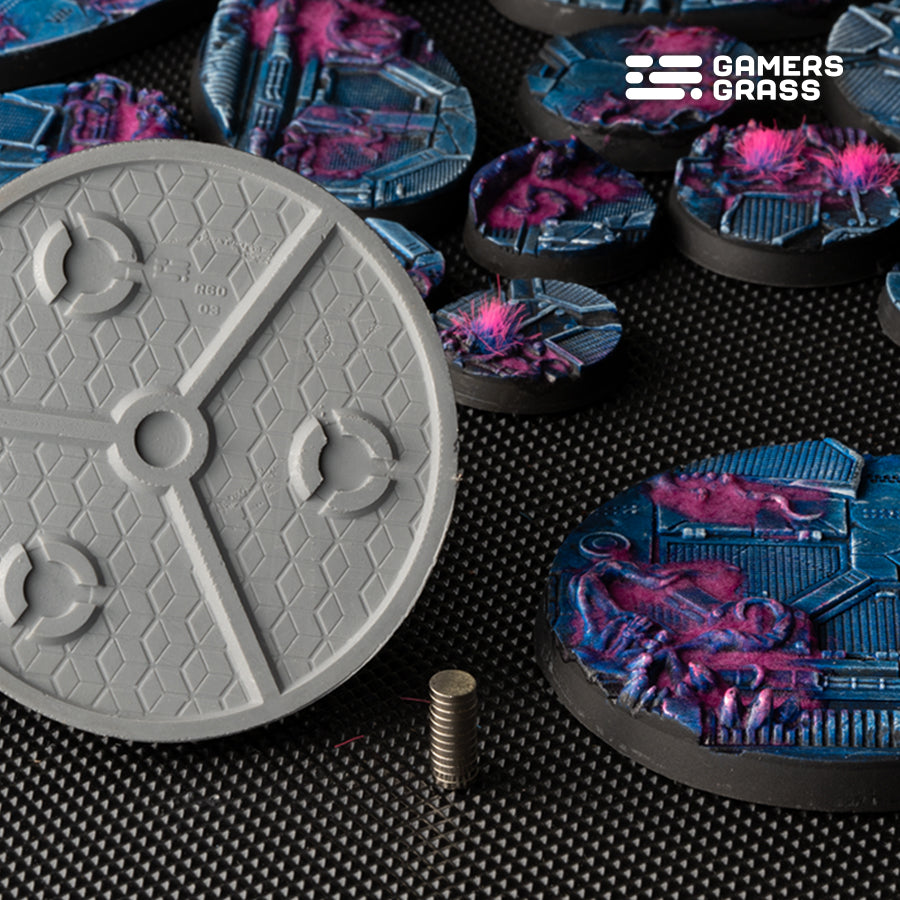 Underside of a 60mm Alien Infestation base: three magnet slots around a central hub, disc magnets stacked beside it