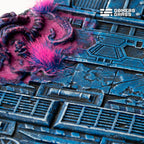 Macro of a 100mm Alien Infestation base: two pink tufts on swollen magenta growth over riveted blue plating