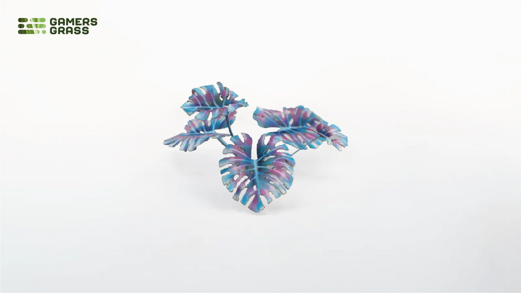 Close-up of assembled Gamers Grass Alien Monstera leaves in blue-teal tones showing laser-cut vein detail